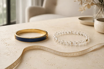 Rigid bangle and flexible bead bracelet beside a measuring tape