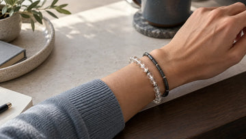Two bracelets with contrasting bead scales worn with space on one wrist