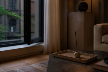 Incense in a small city apartment beside an open window and heat-safe tray