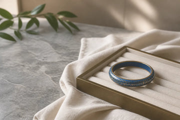 Generic cloisonné-style bangle stored in a lined tray for careful jewelry care